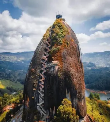 a tall building with vegetation on top of it at Serenity house Guatapé in Guatapé