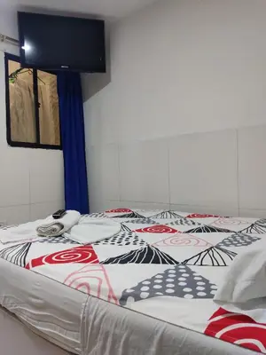 a bed with a coca cola blanket on it at TURISTAS Hostel in Jardin