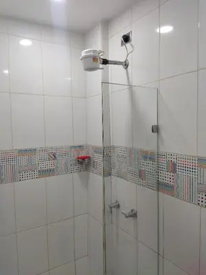 a shower with a glass door in a bathroom at TURISTAS Hostel in Jardin
