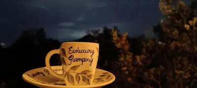 a cup and a saucer with writing on it at refugio amazonico in Rionegro