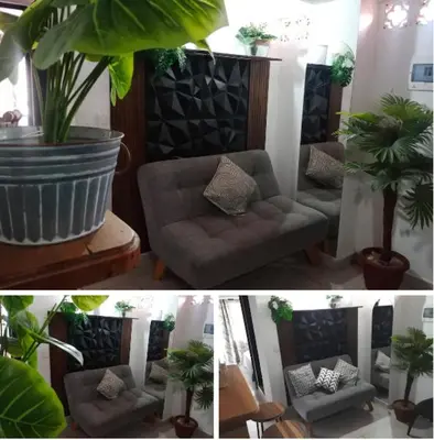 a living room with a couch and a plant at Apartamento en Itagüí in Itagüí