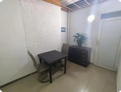 a room with a desk and a chair and a cabinet at Acogedor Aparta Hotel para 3H Belén Rosales apt 202 in Medellín