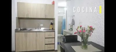 a kitchen with a sink and a vase of flowers at Acogedor Aparta Hotel para 3H Belén Rosales apt 202 in Medellín