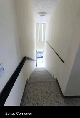 a staircase in a building with a stair case at Acogedor Aparta Hotel para 3H Belén Rosales apt 202 in Medellín
