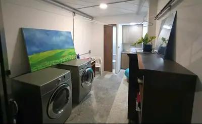 a laundry room with a washing machine and a tv at Acogedor Aparta Hotel para 3H Belén Rosales apt 202 in Medellín