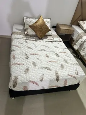 a bed in a room with a bedskirtspectspectspects at Hotel Lesus in Medellín