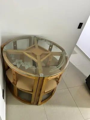 a coffee table with a glass top on a floor at Hotel Lesus in Medellín
