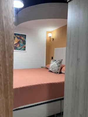 a small bedroom with a bed in a room at Hotel Lesus in Medellín