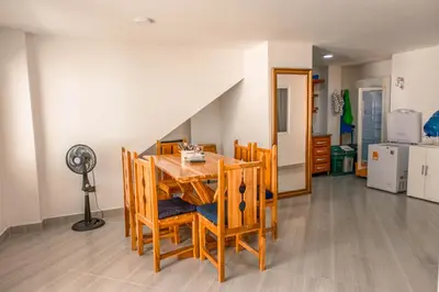 a dining room with a table with chairs and a fan at Casa Finca La Nana in San Jerónimo