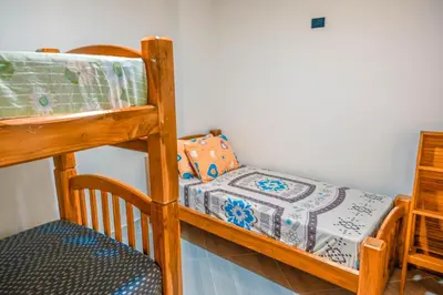a bedroom with a bunk bed with a crib at Casa Finca La Nana in San Jerónimo