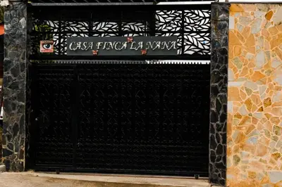 a black garage door with a sign on it at Casa Finca La Nana in San Jerónimo