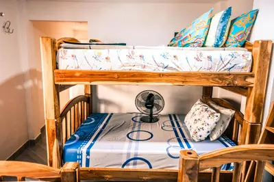 a bunk bed with a fan on the bottom bunk at Casa Finca La Nana in San Jerónimo