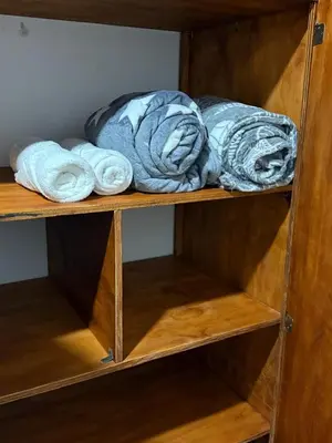a wooden shelf with towels on top of it at En la Zona Rosa, a una cuadra del Parque in Urrao