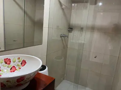 a bathroom with a shower and a bowl sink at En la Zona Rosa, a una cuadra del Parque in Urrao