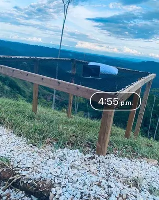 a wooden bench sitting on top of a mountain at Cabaña Campestre EN RIO CLARO- Doradal, Antioquia in Mesa del Norte