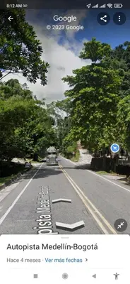 an empty road with a car driving down the road at Cabaña Campestre EN RIO CLARO- Doradal, Antioquia in Mesa del Norte