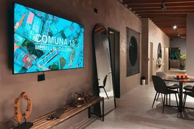 a television hanging on a wall in a room at URBAN COMFORT POBLADO SUIT's in Medellín