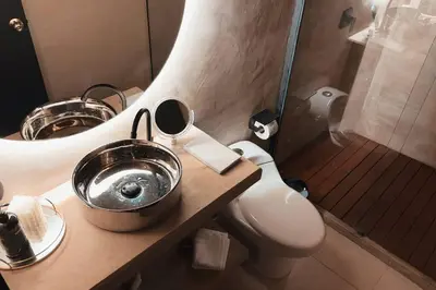 a bathroom with two sinks and a toilet and a shower at URBAN COMFORT POBLADO SUIT's in Medellín