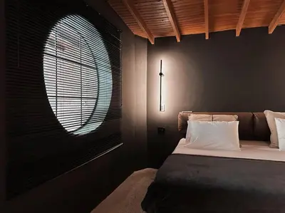 a bedroom with a large bed and a window at URBAN COMFORT POBLADO SUIT's in Medellín