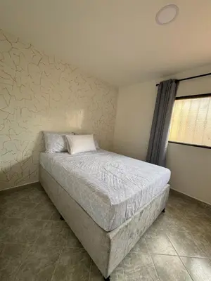a bedroom with a bed in a room with a wall at Casa San Miguel 101 in Medellín