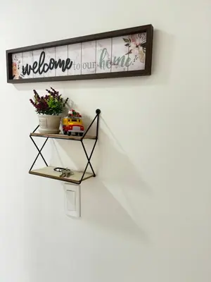 a shelf on the wall with a welcome to our room at Casa San Miguel 101 in Medellín