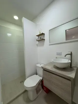 a bathroom with a white toilet and a sink at Casa San Miguel 101 in Medellín