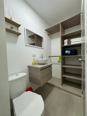 a bathroom with a white toilet and a sink at Casa San Miguel 101 in Medellín