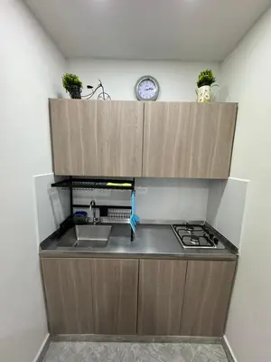 a kitchen with a sink and a clock on the wall at Casa San Miguel 101 in Medellín