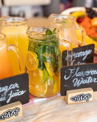 a table with mason jars filled with citrus juice at Heiss Hotel By Jalo in Medellín