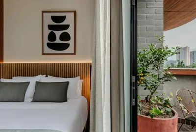 a hotel room with a bed and a window at Heiss Hotel By Jalo in Medellín
