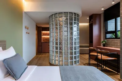 a hotel room with a bed and a large column at Heiss Hotel By Jalo in Medellín