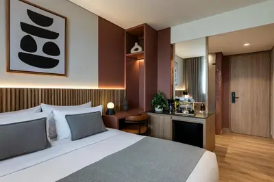 a hotel room with a bed and a bathroom at Heiss Hotel By Jalo in Medellín