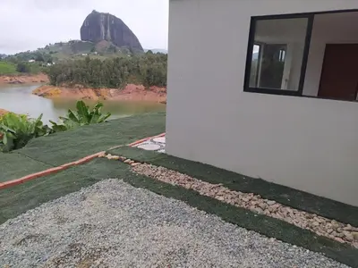 a building with a view of a river and a mountain at Cabaña Estancia Primavera in Guatapé