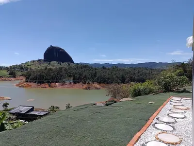 a view of a river with a mountain in the background at Cabaña Estancia Primavera in Guatapé