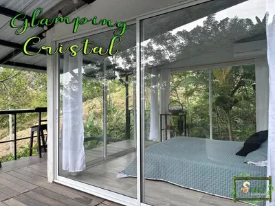 a screened in porch with a bed on it at Saray glamping in Palestina