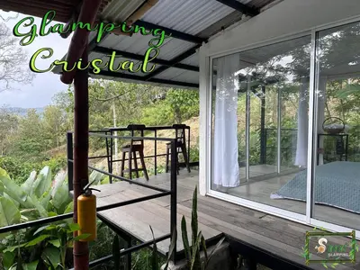 a screened in porch with a sliding glass door at Saray glamping in Palestina