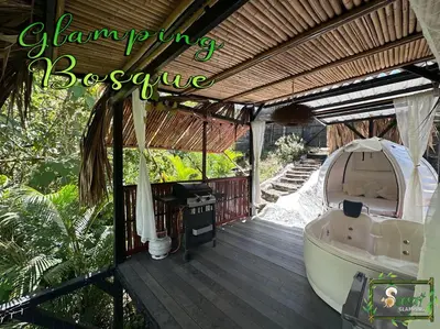 a bath tub sitting on a wooden deck with a tent at Saray glamping in Palestina