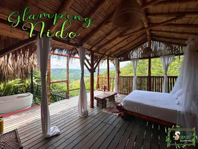 a bed in a pavilion on a wooden deck at Saray glamping in Palestina