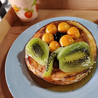 a waffle with fruit on a plate on a table at Boresta House -Santa Elena con vista al Bosque y terraza privada in Medellín