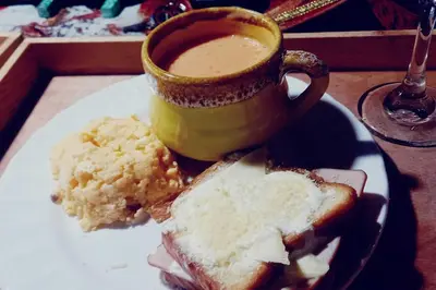 a plate with a sandwich and a cup of coffee at Boresta House -Santa Elena con vista al Bosque y terraza privada in Medellín
