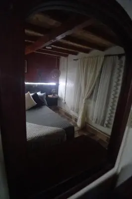 a mirror reflection of a bed in a room at Boresta House -Santa Elena con vista al Bosque y terraza privada in Medellín