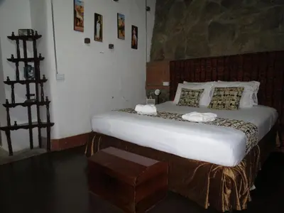 a bedroom with a large bed in a room at Hotel El Tesoro Sonson in Sonsón