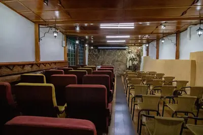 a room with rows of chairs in a building at Hotel El Tesoro Sonson in Sonsón