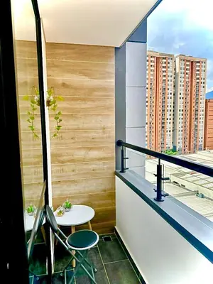 a balcony with a table and a view of a city at Apartamento Premium Sabaneta in Sabaneta