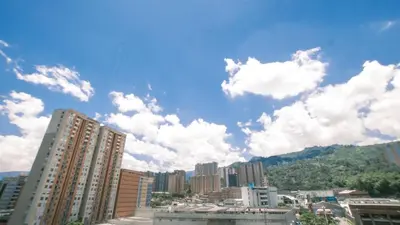 a city with tall buildings and clouds in the sky at Apartamento Premium Sabaneta in Sabaneta