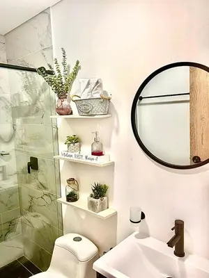 a bathroom with a toilet and a sink and a mirror at Apartamento Premium Sabaneta in Sabaneta