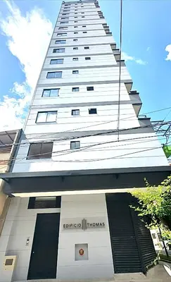 a tall white building with a sign on it at Apartamento Premium Sabaneta in Sabaneta
