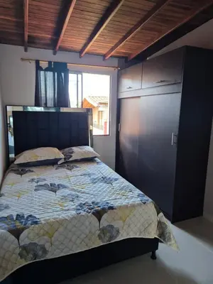 a bedroom with a bed and a large window at EXCLUSIVO y ELEGANTE APARTAMENTO in Medellín