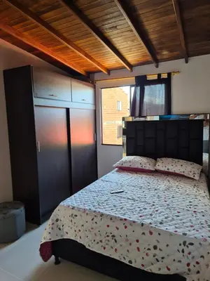 a bedroom with a bed and a large window at EXCLUSIVO y ELEGANTE APARTAMENTO in Medellín