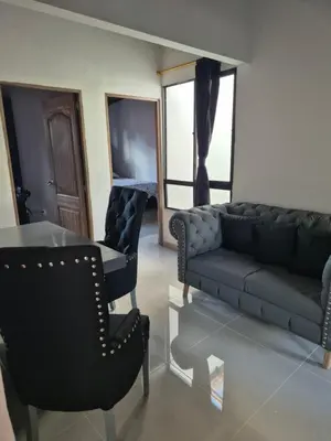 a living room with a couch and a table and chairs at EXCLUSIVO y ELEGANTE APARTAMENTO in Medellín